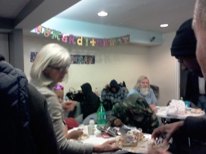 Jane serves a guest a slice of king cake.